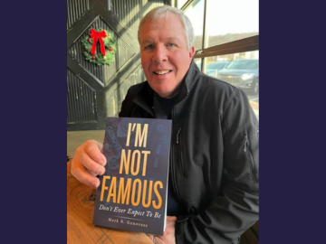 photo of mark genovese holding his book "i'm not famous"