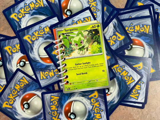 Pokemon cards scattered across a brown table